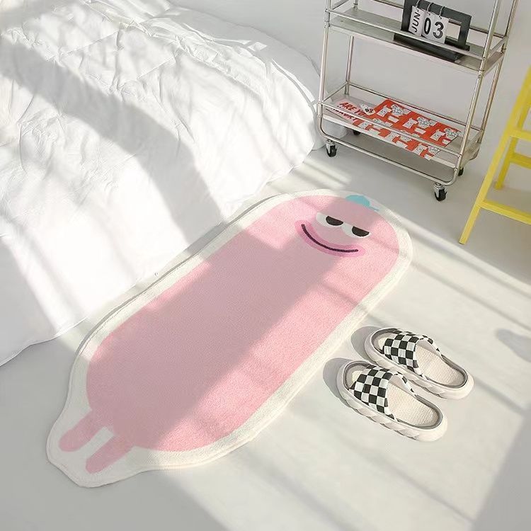 VibeCore Lil Blob Guy Accent Rug in pink with a smiley face design. The playful, quirky rug adds a fun touch to any room with its plush texture and non-slip backing, perfect for living rooms, bedrooms, or dorms.