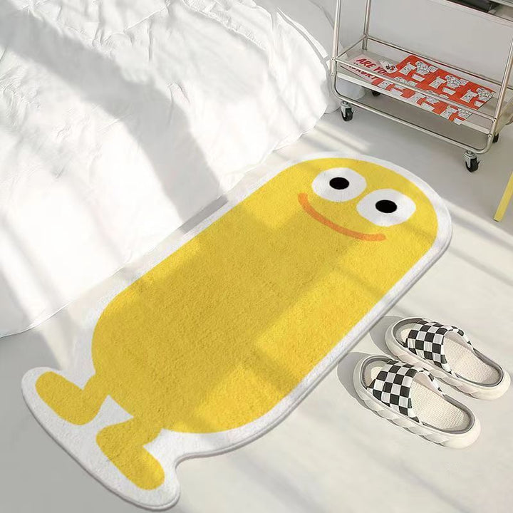 VibeCore Lil Blob Guy Accent Rug in yellow with a smiling, quirky blob character in the center. This fun and vibrant rug brings personality to any room, offering a soft, plush feel with a non-slip backing for safety. Ideal for bedrooms, living rooms, or dorms, adding warmth and charm to your space.