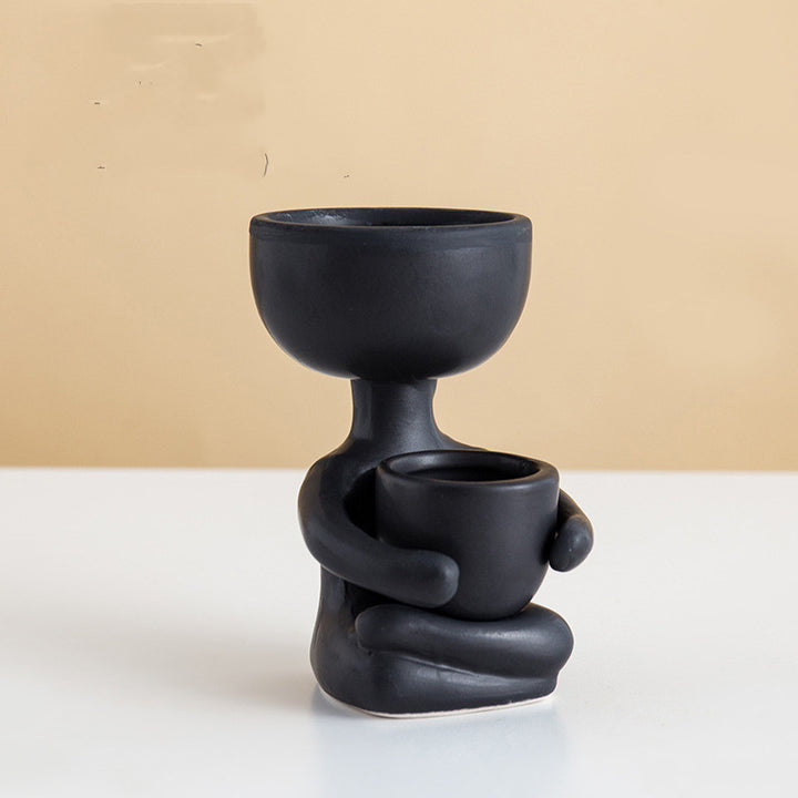 VibeCore Lil Buddy Planter in black, quirky humanoid design, Nordic-inspired style, crafted from premium clay, perfect for adding a playful yet stylish touch to your plant display.
