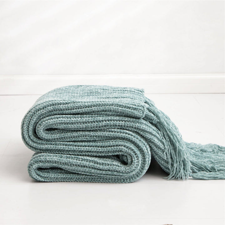 Aqua Long Tassel Knitted Throw Blanket, offering a chic tassel design and ultra-soft comfort. Crafted from premium polyester, this cozy blanket adds texture and flair to any space. Perfect for dorm rooms, living rooms, or any cozy corner.