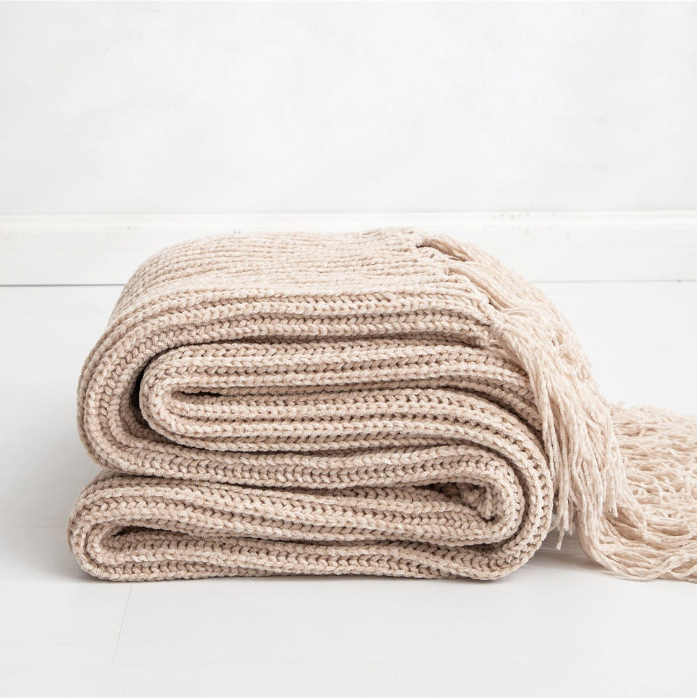 Beige Long Tassel Knitted Throw Blanket, offering a chic tassel design and ultra-soft comfort. Crafted from premium polyester, this cozy blanket adds texture and flair to any space. Perfect for dorm rooms, living rooms, or any cozy corner.