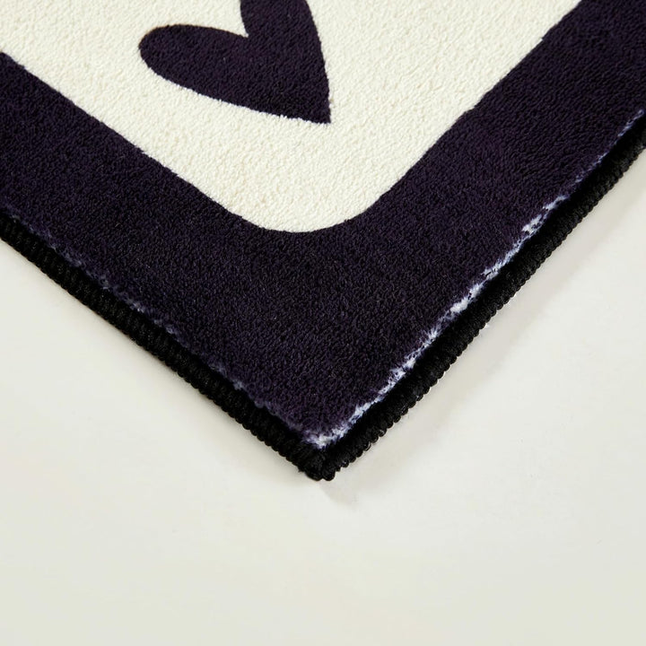 Aesthetic black and white "Lucky You" accent rug with a playful card design, shown in a corner close-up. This detailed view highlights the plush texture, precise stitching, and non-slip backing, making it a stylish and functional addition to any bedroom, dorm, or cozy space.