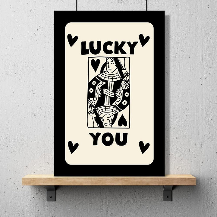 Playful 'Lucky You Queen' canvas poster with a bold queen playing card design, featuring black and gold details for a trendy, retro-inspired vibe, perfect for adding personality to any room.