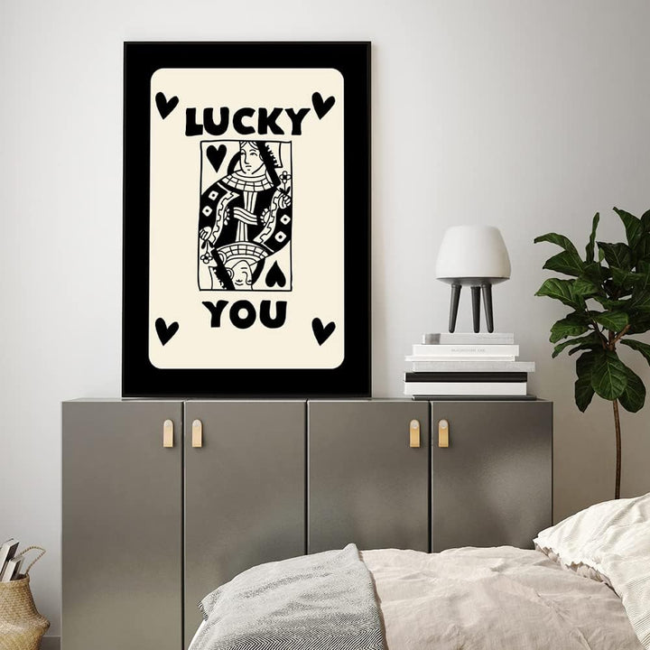 'Lucky You Queen' canvas poster in a bedroom, featuring a bold queen playing card design with a striking black and gold color scheme, adding a playful, retro vibe to the room's decor.