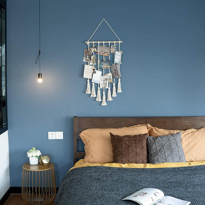 VibeCore Macrame Photo Wall Hanging Display on bedroom wall, showcasing 30 wooden clips for photos, postcards, and prints, adding a boho touch to your room decor.