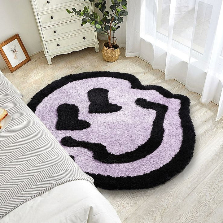 VibeCore Melting Smiley Accent Rug Purple Beside Bed, showcasing the playful design and vibrant color adding a fun and energetic vibe to the bedroom space.