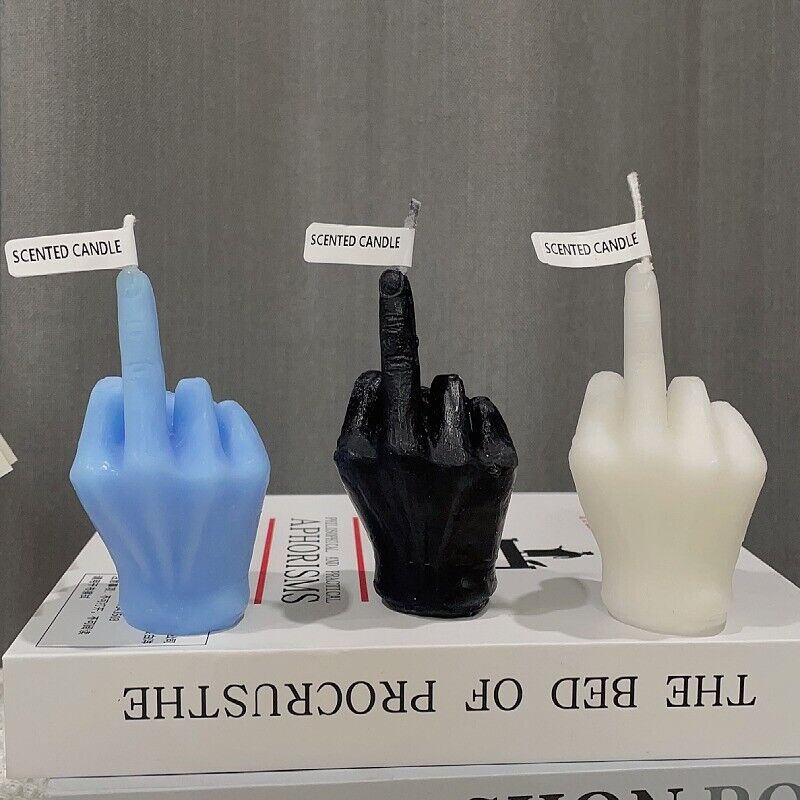 All three colors of the middle finger candle: black, white, and blue, displayed together.