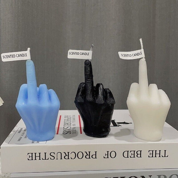 All three colors of the middle finger candle: black, white, and blue, displayed together.