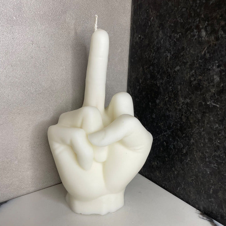 White eco-friendly soy wax candle shaped like a middle finger with a sleek cylindrical base.