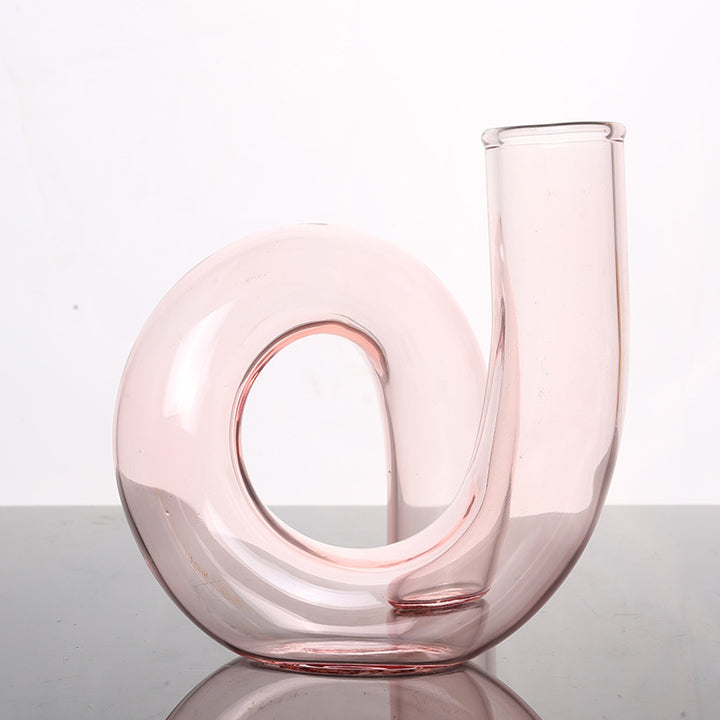 VibeCore Modern Twist Glass Candle Holder in light pink, with a sleek, polished finish, perfect for small candles or fresh flowers, adding a modern, minimalist touch to any space.