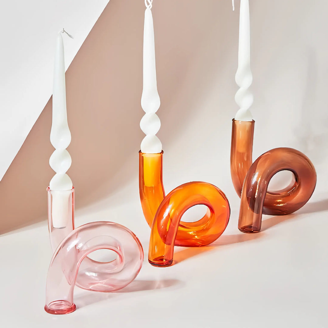 VibeCore Modern Twist Glass Candle Holders in light pink, orange, and brown glass, sleek dual-use vases and candle holders for colorful modern decor accents.