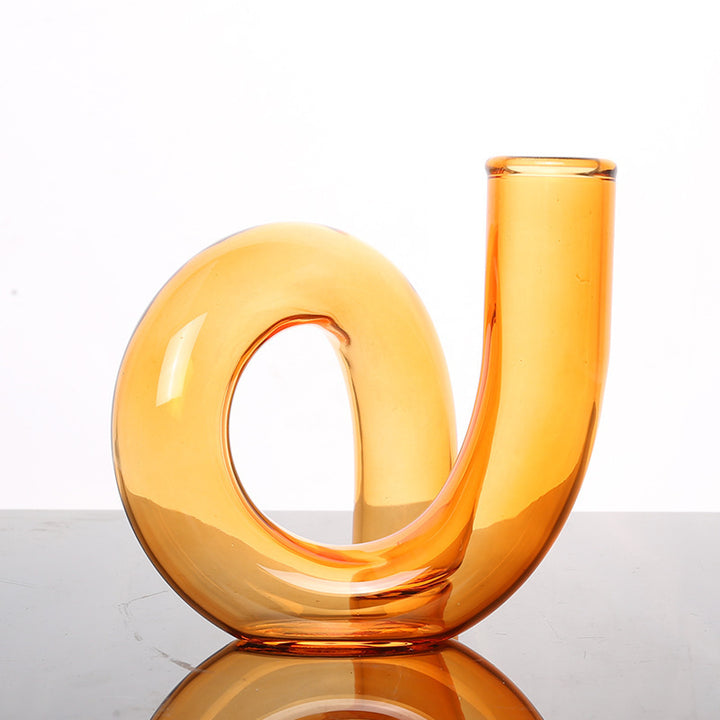VibeCore Modern Twist Glass Candle Holder in orange, with a sleek, polished finish, perfect for small candles or fresh flowers, adding a modern, minimalist touch to any space.