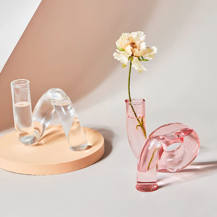 VibeCore Modern Twist Glass Candle Holders in transparent and light pink borosilicate glass, with sleek twisted design for contemporary shelf or table decor.