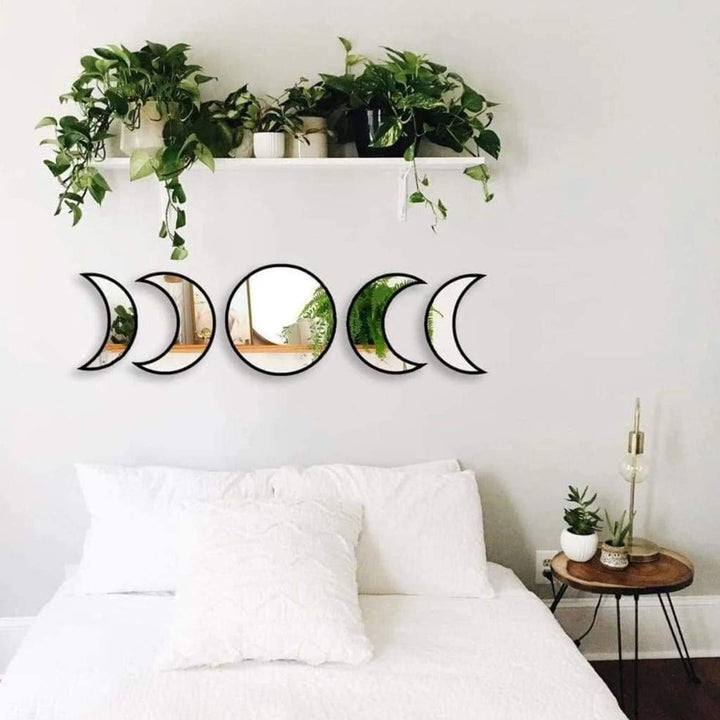 VibeCore Moon Phases Mirror Set in black, displayed in another bedroom. Featuring sleek black mirrors that showcase the phases of the moon, this set adds a mystical, boho-inspired touch to the room. Perfect for enhancing celestial or bohemian-themed decor, it creates a unique, cosmic ambiance in any bedroom.