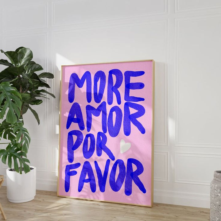 ‘More Amor Por Favor’ pink canvas poster angled against the wall, featuring a playful, bold love message in a vibrant, modern design.