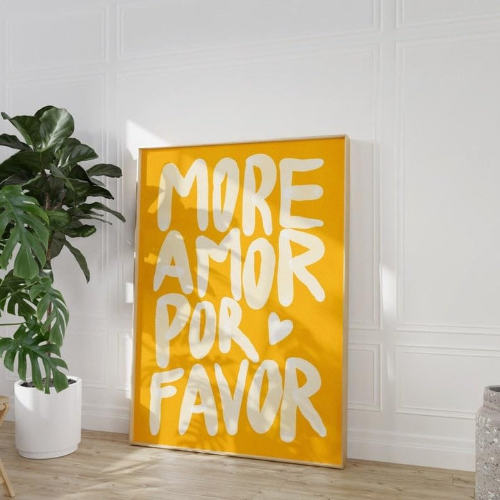 Angled view of vibrant yellow ‘More Amor Por Favor’ canvas poster leaning against a wall, featuring a bold, playful love message with a maximalist design, perfect for adding personality and warmth to any room.