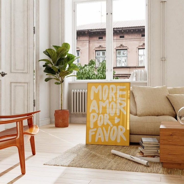 Yellow ‘More Amor Por Favor’ canvas poster displayed in a cozy living room, adding a vibrant, playful touch with its bold love message and modern eclectic design.
