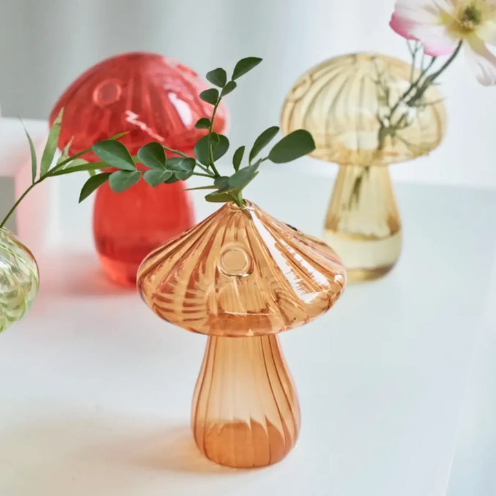 Mushroom Glass Vase in orange with flowers inside, highlighting its whimsical design and vibrant floral display