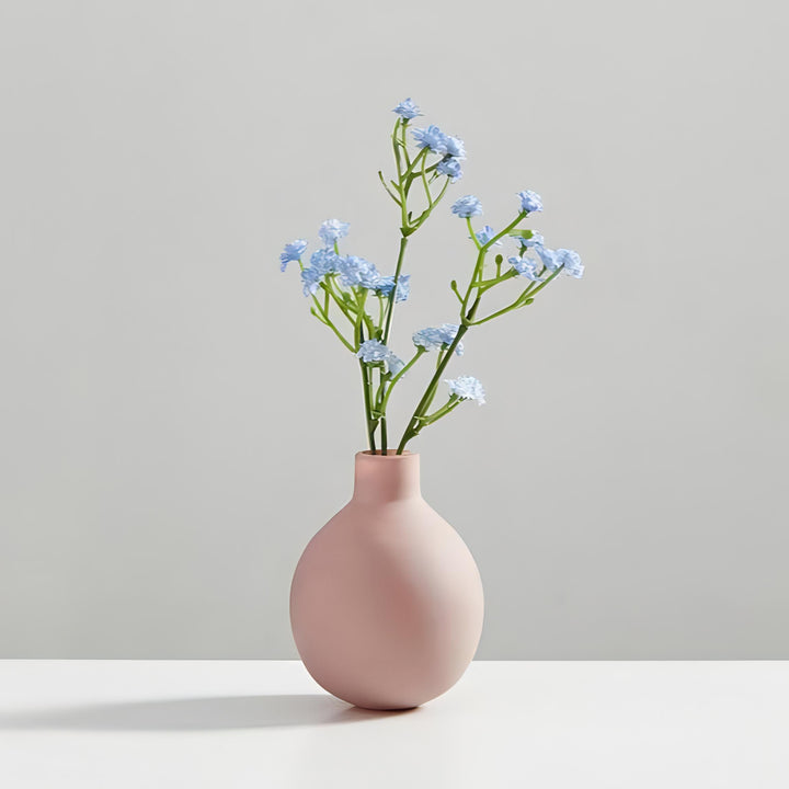 VibeCore Nordic Ceramic Vase Pink Mini with flowers, showcasing a minimalist design with sleek lines and a matte finish, perfect for adding a modern touch to any space while beautifully highlighting floral arrangements.