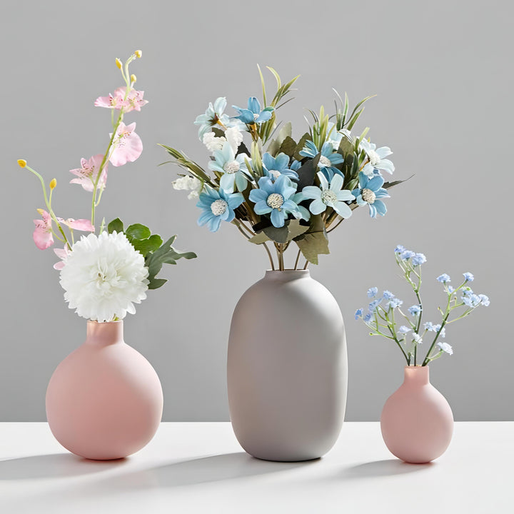 VibeCore Nordic Ceramic Vases in pink, mini pink, and gray with flowers arranged inside, highlighting minimalist floral ceramic decor.