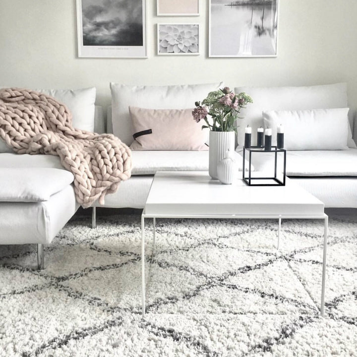 The VibeCore Nordic Shaggy Area Rug placed in another living room, enhancing the space with its soft, plush texture and minimalist Scandinavian design. The rug’s neutral tones add warmth and comfort to the room’s decor.