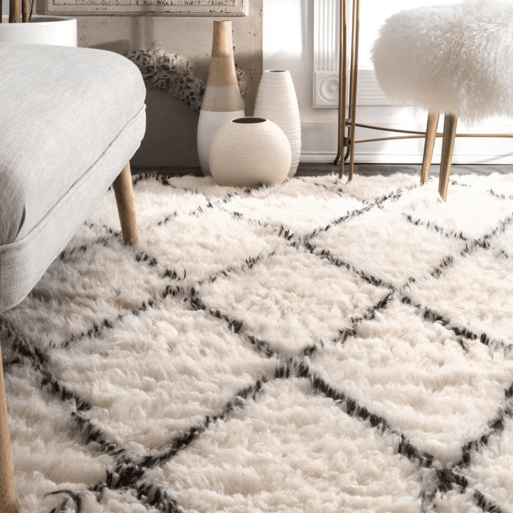 Close-up of the VibeCore Nordic Shaggy Area Rug in a living room, showcasing its soft, plush texture and luxurious hand-woven polyester material. The rug’s clean, minimalist design adds warmth and comfort to the space.
