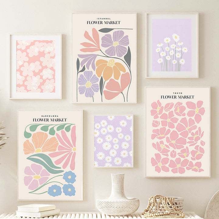 Framed collage of ‘Pastel Flower Market’ canvas posters displayed on the wall, featuring vibrant pastel flower prints from global cities like Barcelona, Istanbul, London, New York, and Tokyo, adding an aesthetic floral touch to the space.