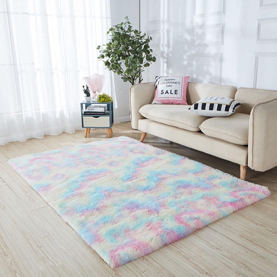 VibeCore Pastel Rainbow Tie-Dye Area Rug material in front of couch, showcasing the soft, plush texture and vibrant colors that bring a fun, cozy vibe to the room.