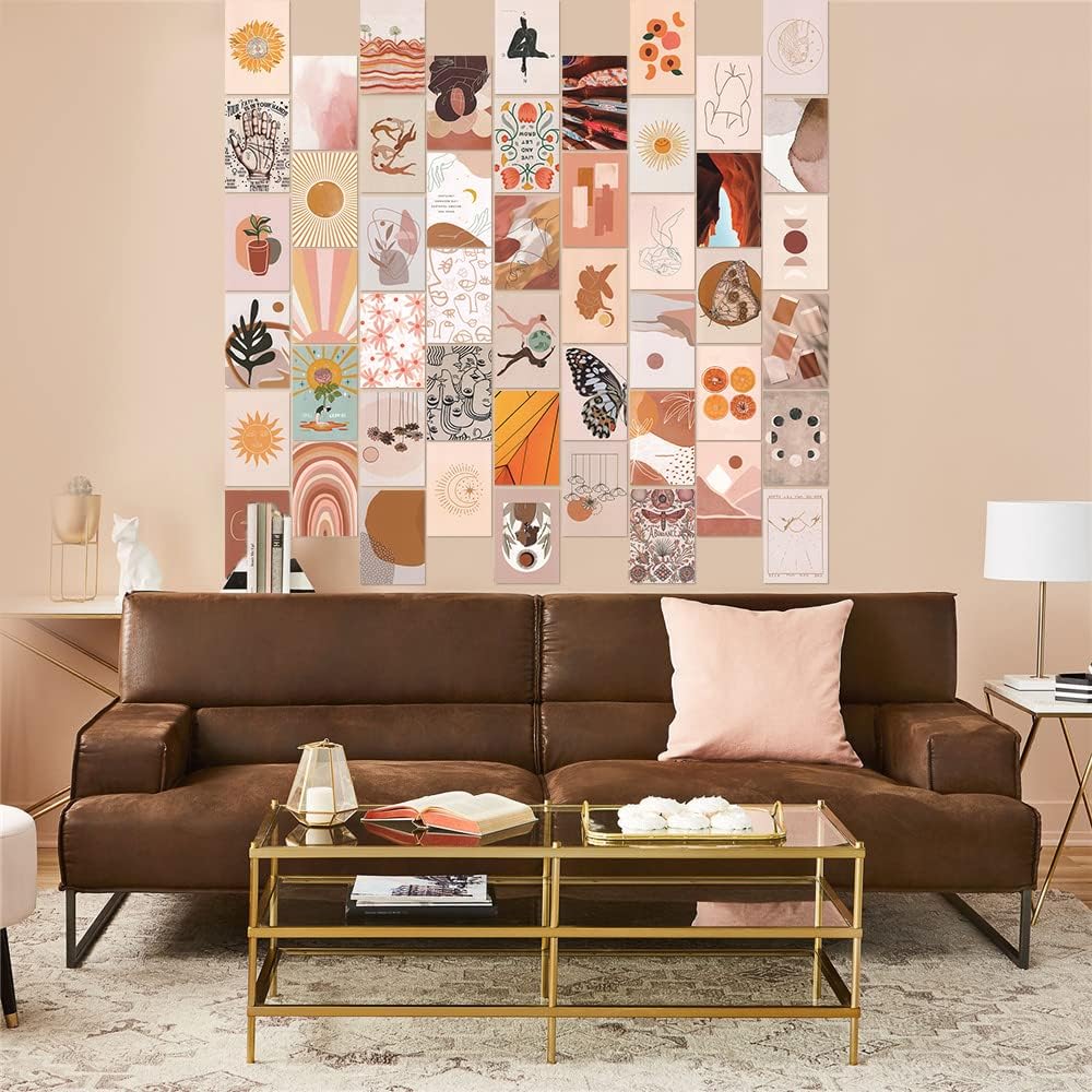 VibeCore Peace Goddess Wall Collage Kit displayed above a couch, featuring 70 calming prints in warm peach and orange tones with goddess-inspired and nature-themed designs. Brings a serene, feminine, and artistic touch to the living space.