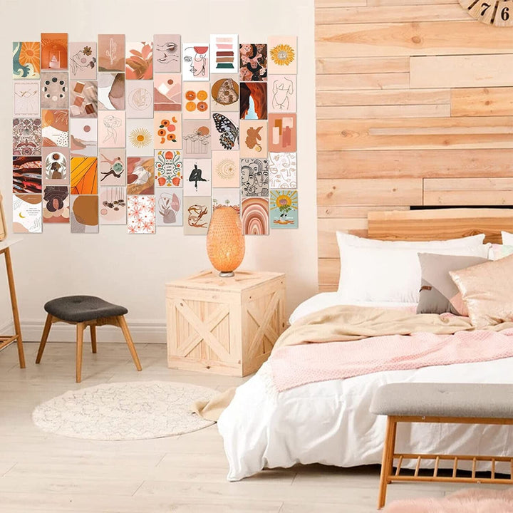 VibeCore Peace Goddess Wall Collage Kit displayed on a bedroom wall, featuring 70 calming prints in warm peach and orange tones with goddess-inspired and nature-themed designs. Adds a serene, feminine, and artistic touch to your bedroom decor.