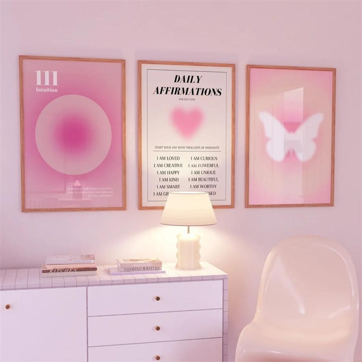 VibeCore Pink Divine Feminine Canvas Posters featuring three framed designs in a bedroom. The posters showcase soft pink and purple gradients, empowering messages, and divine feminine symbols, creating a peaceful and inspiring atmosphere in the room.