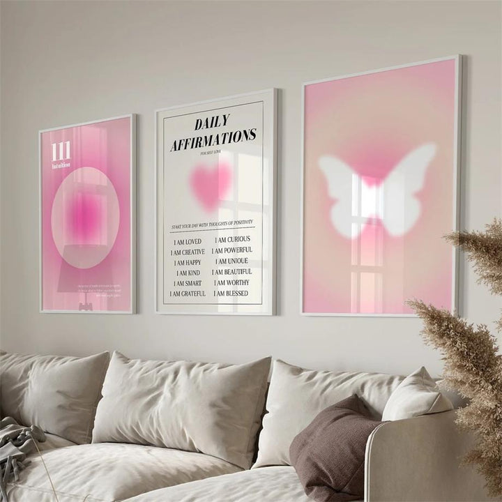 VibeCore Pink Divine Feminine Canvas Posters featuring three framed designs in a living room. The posters display soft pink and purple gradients with empowering messages and divine feminine imagery, adding a calming, inspiring touch to the space.