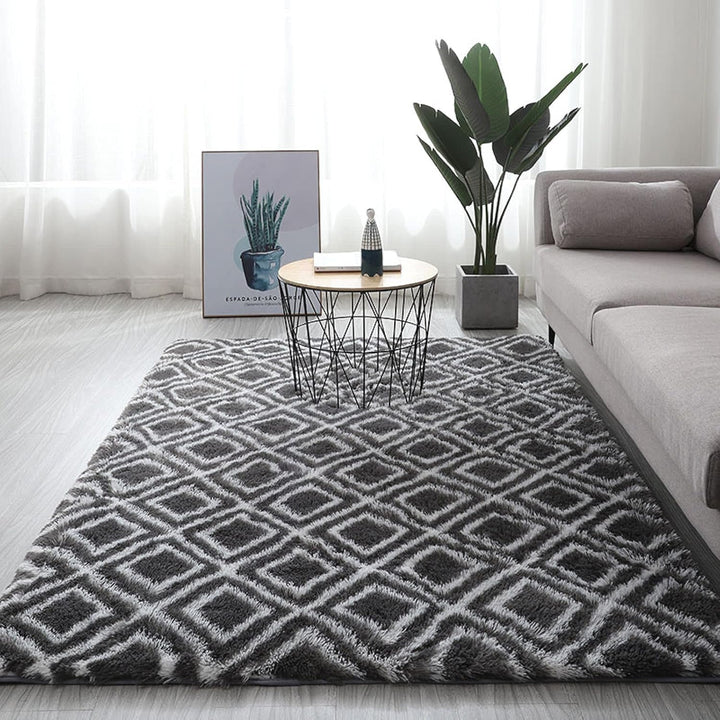 VibeCore Plush Patterned Area Rug in white design on a black background, placed on the living room floor, showcasing its soft polyester fiber texture and non-slip backing. Adds comfort and style to your space. Easy to clean and available in 5 stylish options.