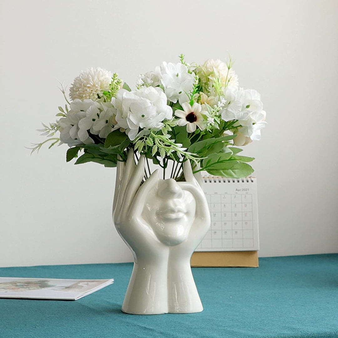 VibeCore Pondering Girl Ceramic Vase styled with soft florals—adds an elegant, artistic accent to your space while showcasing its functionality as a flower holder.