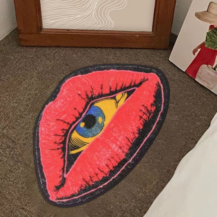 VibeCore Psychic Lips Accent Rug placed on a bedroom floor, showcasing its bold lip design with a mystical gaze, adding an artistic touch to the room's decor.