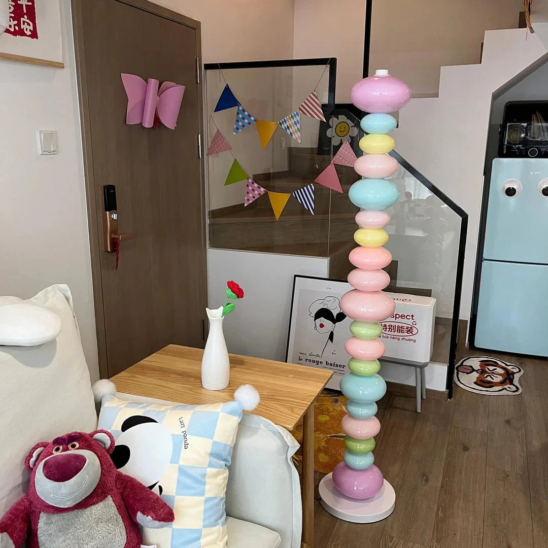 VibeCore Rainbow Candy Floor Lamp In Apartment – The colorful Rainbow Candy Floor Lamp glowing in an apartment setting, with its playful candy-inspired design and sleek metal base adding a vibrant touch to the room's decor.