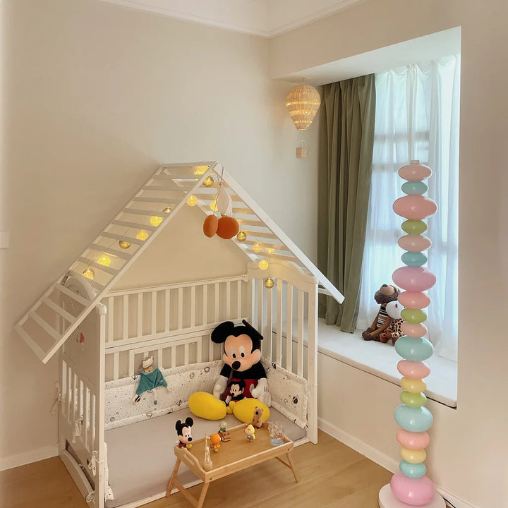 VibeCore Rainbow Candy Floor Lamp In Baby's Room – The colorful Rainbow Candy Floor Lamp illuminating a baby's room, with its playful and bright design adding a fun and whimsical touch to the space, perfect for a cozy, cheerful atmosphere.