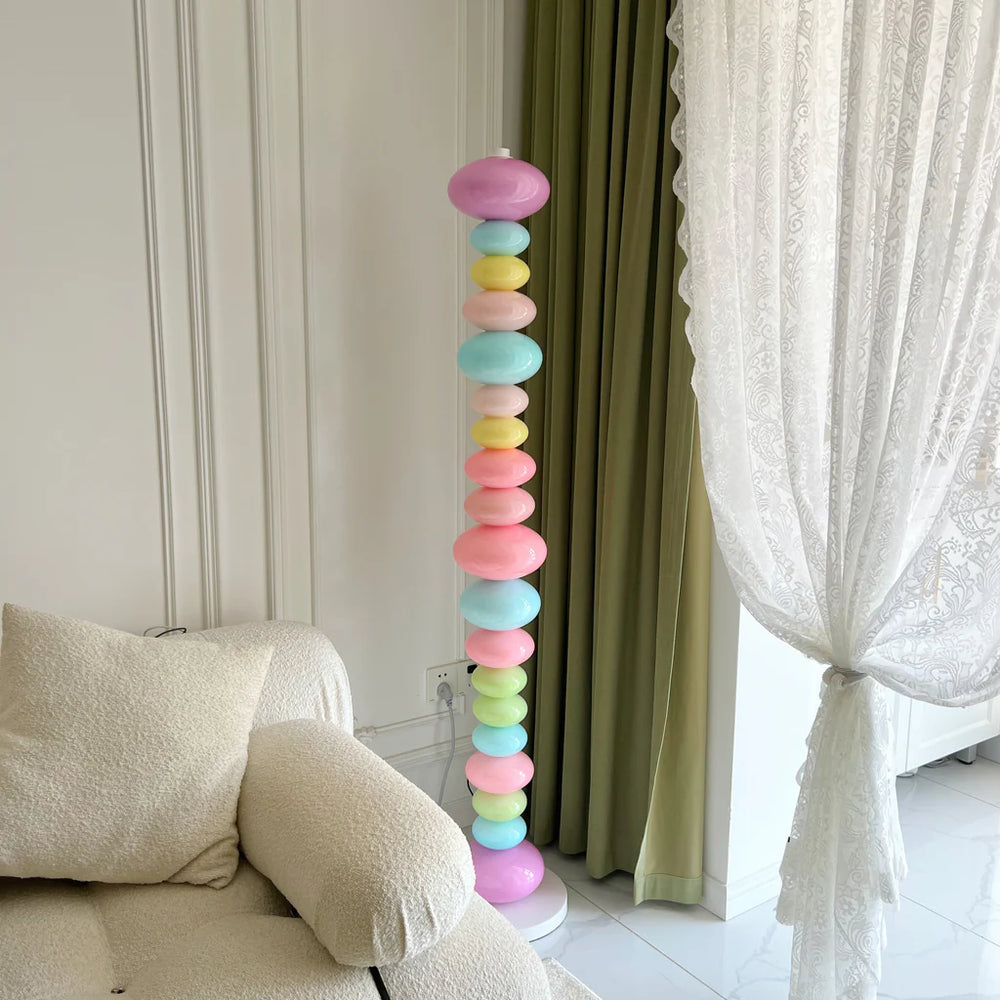 VibeCore Rainbow Candy Floor Lamp Unlit In Aesthetic Living Room – Unlit rainbow candy-inspired floor lamp in a stylish, eclectic living room. Featuring a sleek metal base and colorful glass design, adding a playful touch to the room’s decor.