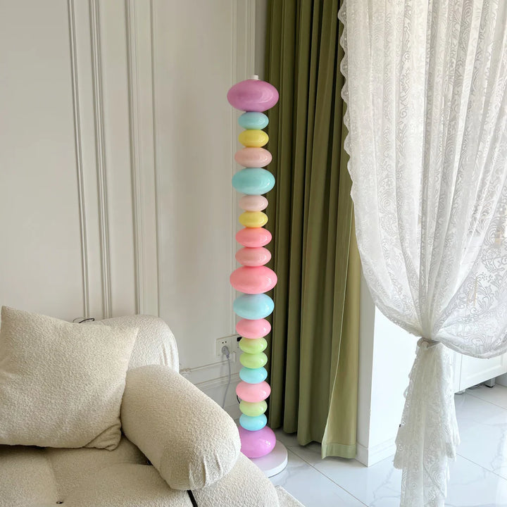 VibeCore Rainbow Candy Floor Lamp Unlit In Aesthetic Living Room – Unlit rainbow candy-inspired floor lamp in a stylish, eclectic living room. Featuring a sleek metal base and colorful glass design, adding a playful touch to the room’s decor.