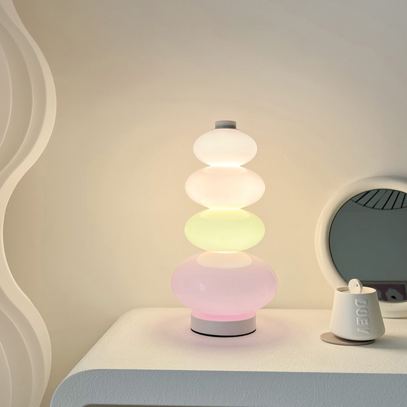 VibeCore Rainbow Candy Table Lamp lit up on a dresser, showcasing its vibrant glass base and playful candy-inspired design.