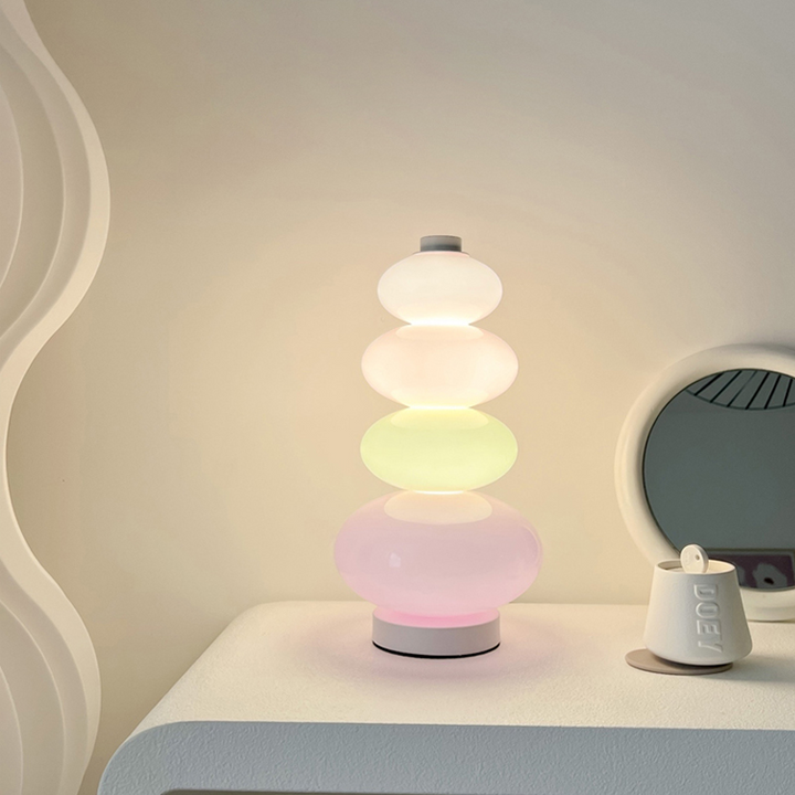 VibeCore Rainbow Candy Table Lamp lit up on a dresser, showcasing its vibrant glass base and playful candy-inspired design.