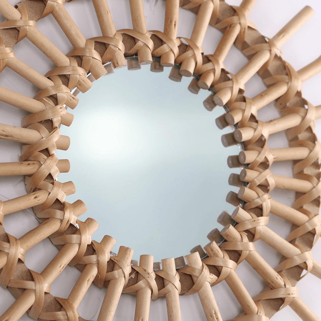 VibeCore Rattan Sun Mirror close-up, highlighting the intricate handwoven natural rattan details and the clear reflective glass in the center.