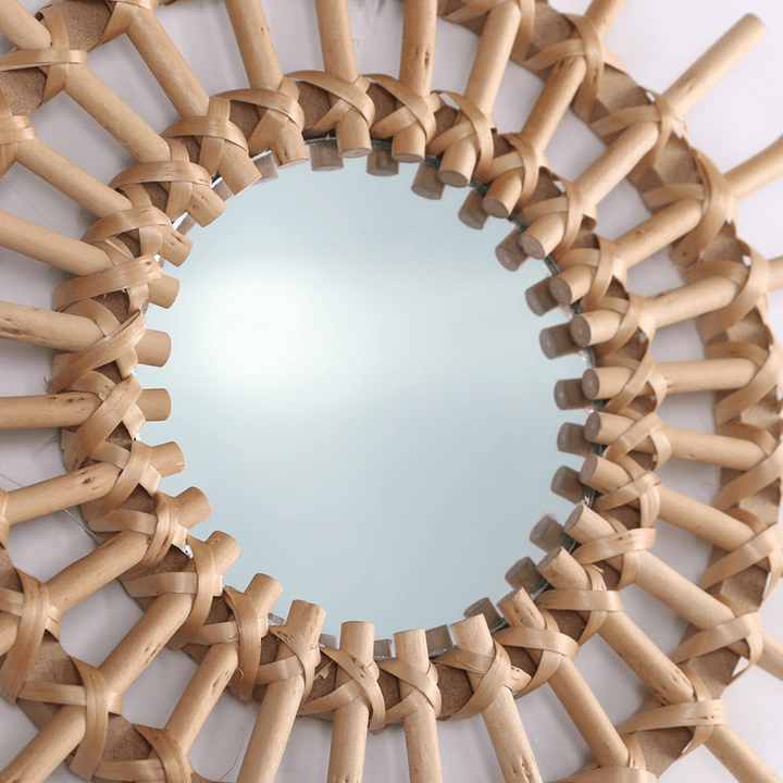 VibeCore Rattan Sun Mirror close-up, highlighting the intricate handwoven natural rattan details and the clear reflective glass in the center.