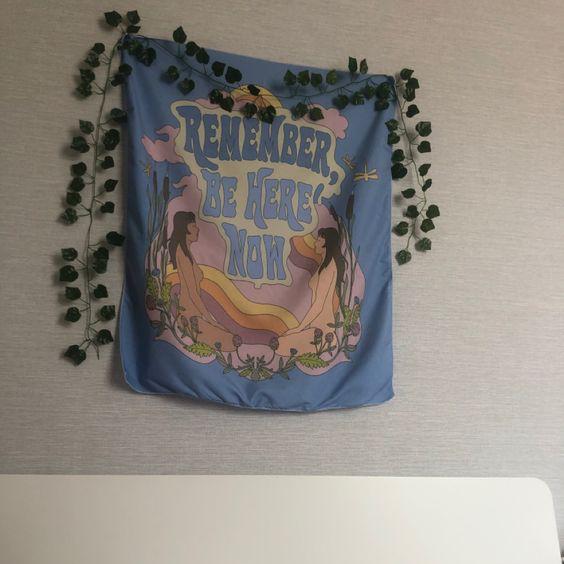 VibeCore Remember Be Here Now Tapestry Hanging With Vine Around It
