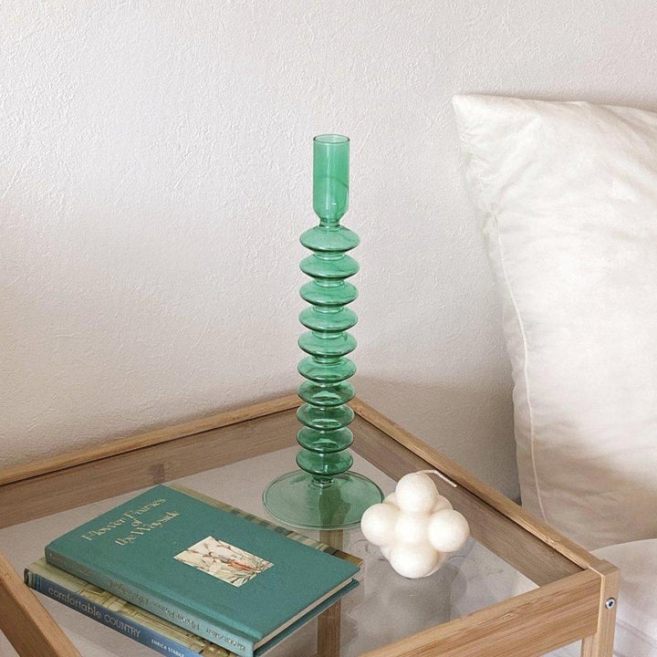 VibeCore Retro Abstract Glass Candle Holder green Option A on side table with minimal modern decor showcasing its geometric shape and hand-blown glass finish.