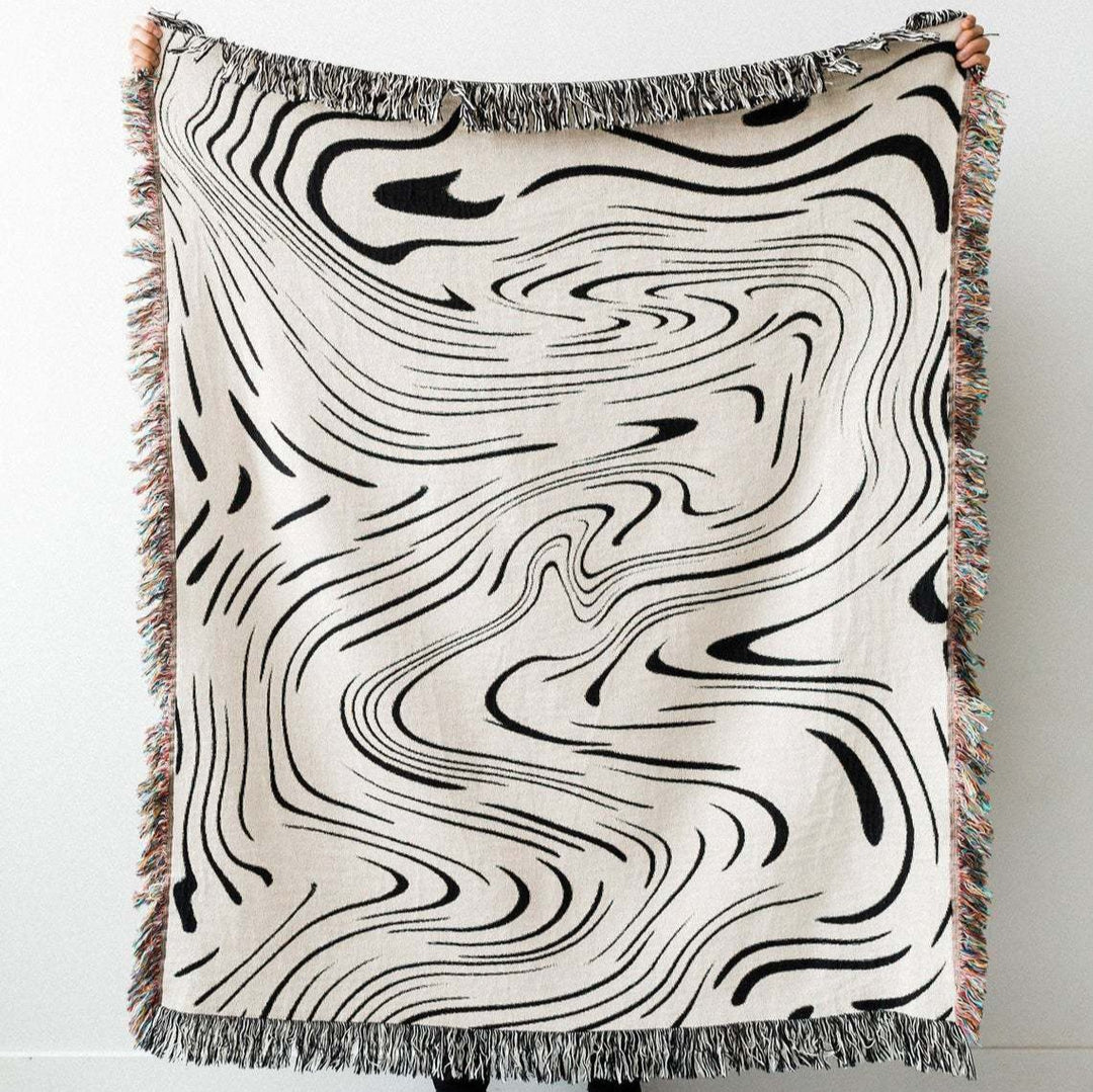 VibeCore Retro Marble Wave Woven Blanket being held up straight on, showcasing spiritual-inspired cosmic design and vibrant reversible patterns in soft 100% combed cotton.