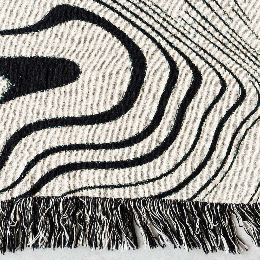 VibeCore Retro Marble Wave Woven Blanket design close-up, highlighting spiritual-inspired cosmic patterns and soft 100% combed cotton texture.