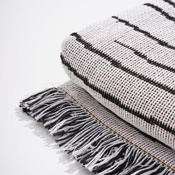 VibeCore Retro Marble Wave Woven Blanket material close-up, highlighting soft 100% combed cotton texture and detailed tassels, with vibrant, spiritual-inspired design.