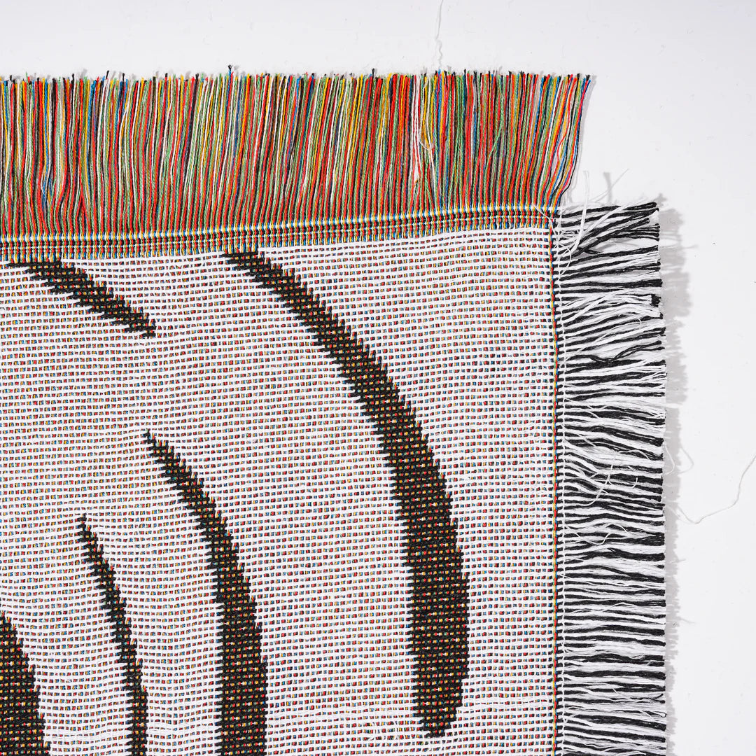 VibeCore Retro Marble Wave Woven Blanket reversible side close-up, showcasing vibrant cosmic design and soft 100% combed cotton texture.