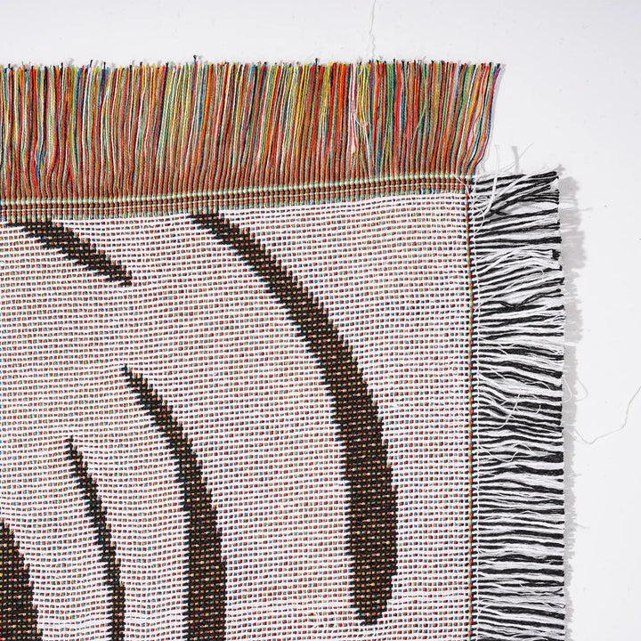 VibeCore Retro Marble Wave Woven Blanket reversible side close-up, showcasing vibrant cosmic design and soft 100% combed cotton texture.